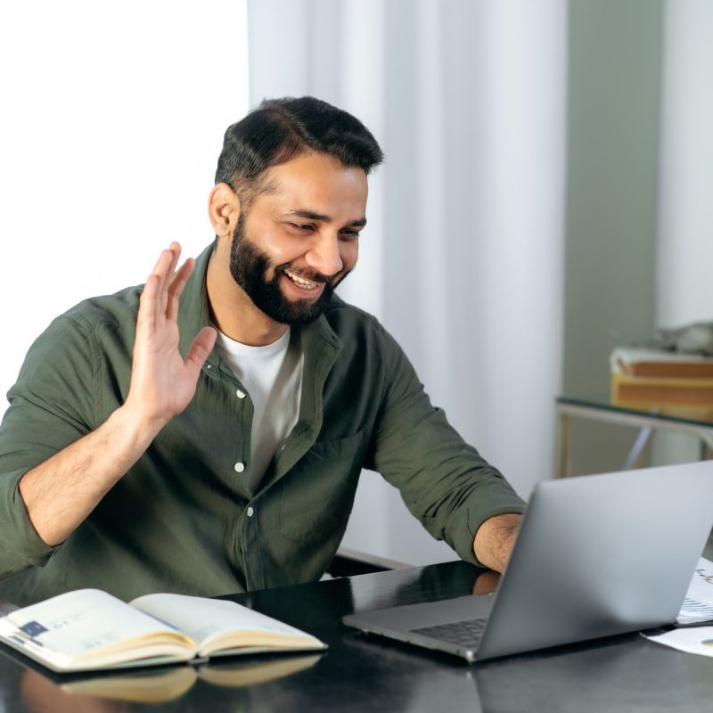 pleasant-friendly-indian-guy-manager-or-financial-consultant-communicates-with-colleagues-on-a.jpg